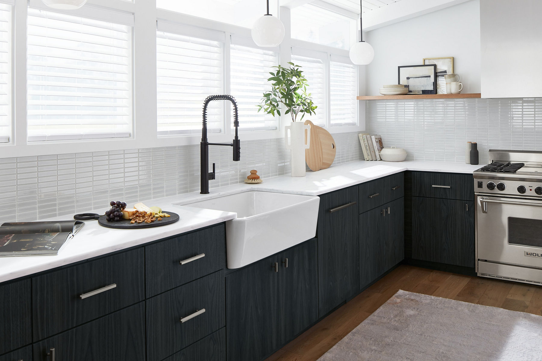 This Ironridge KOHLER sink anchors a modern kitchen with dark cabinetry and a matte black industrial-style faucet.