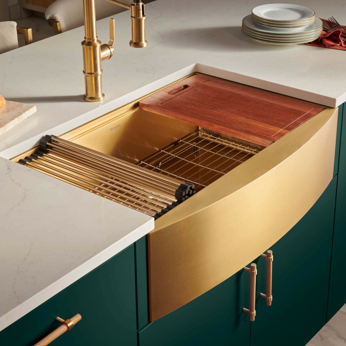 A close-up of the Monaco sink highlights the gentle curve of the apron front and Ruvati’s signature gold tone. Copyright: Ruvati