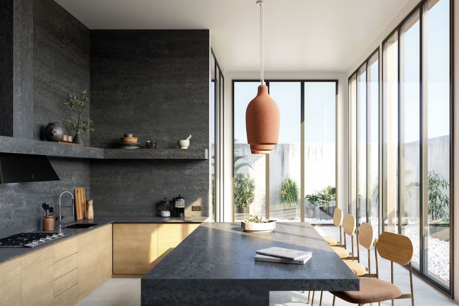 Open-concept kitchen with a large travertine-look island that visually links the cooking area to the dining and living zones.