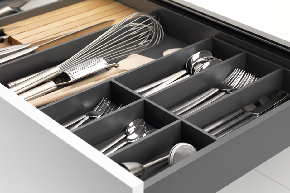 Open drawer with a GRASS Tavinea organizer containing cutlery, spices, wooden utensils, whisks, a rolling pin, and neatly arranged dividers.