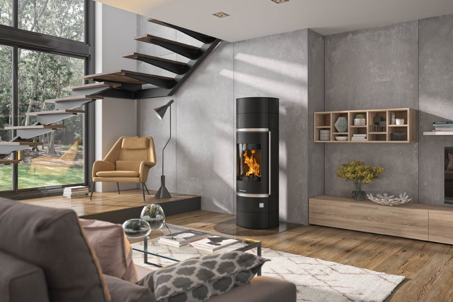 Open-concept living and dining area with staircase, hardwood floors, and a sleek ORANIER wood stove; the fireplace as a stylish design feature.