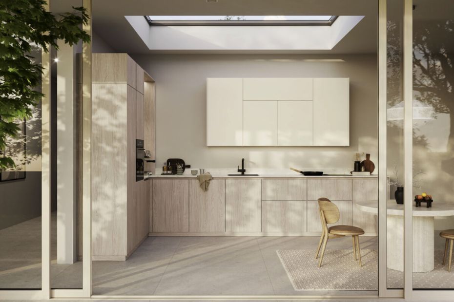 Bright Rotpunkt kitchen with a skylight, light wood cabinetry and minimalist white wall units.